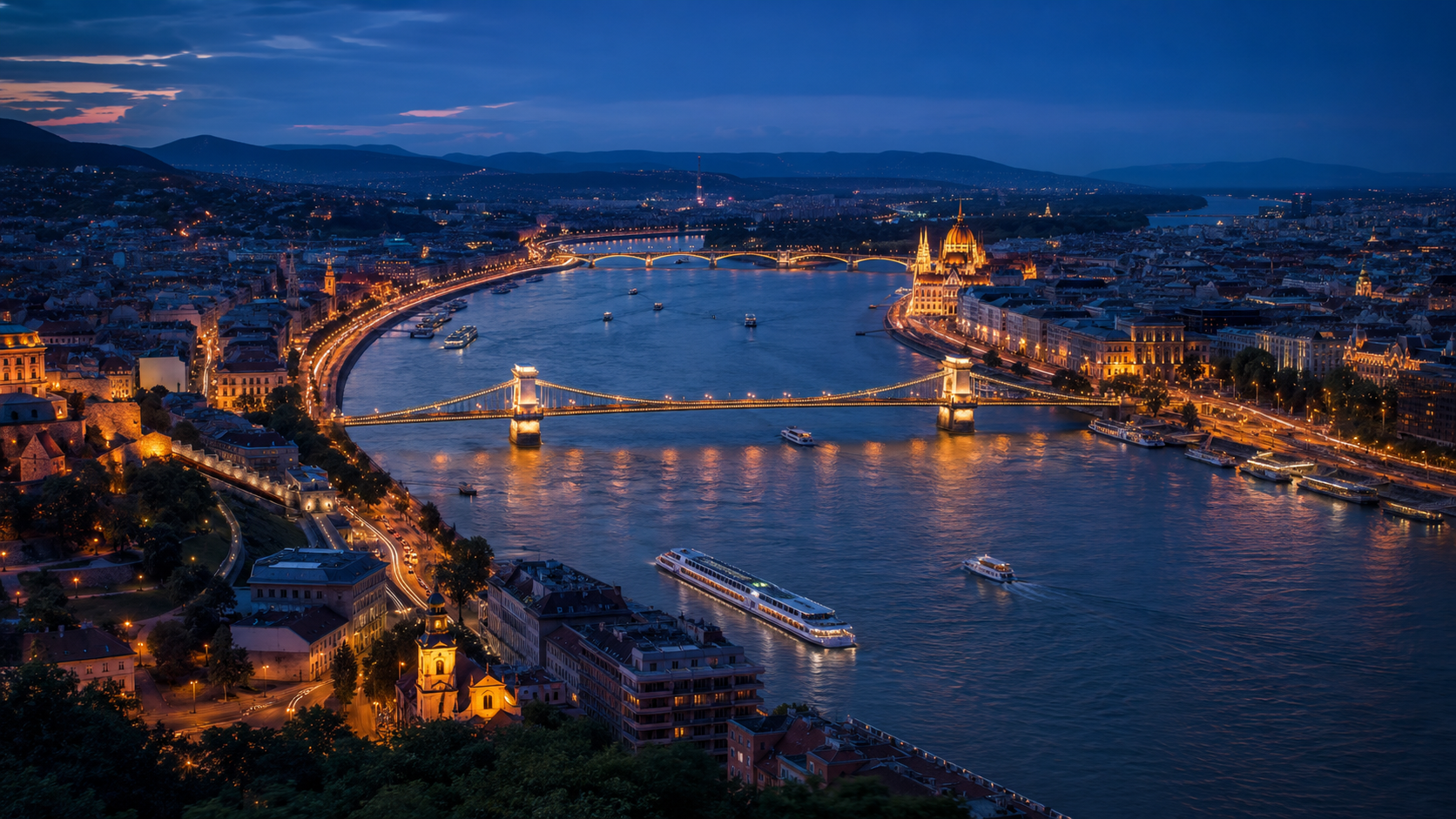 Aerial night view of Budapest with the illuminated bridges and the curve of the Danube