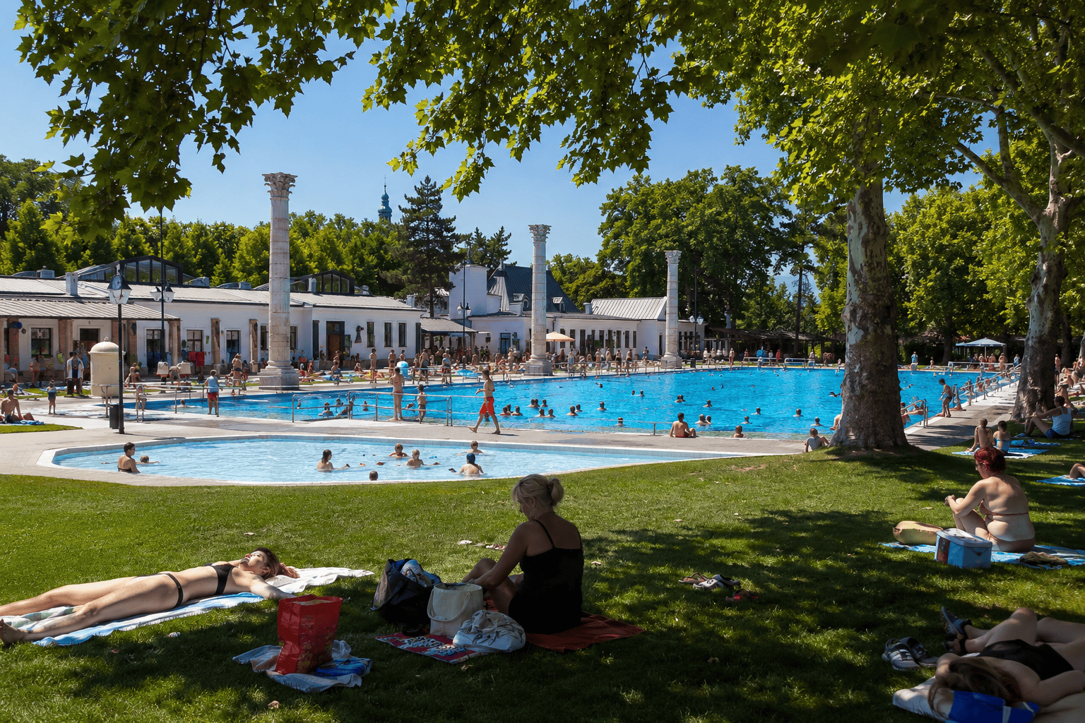 Grand outdoor thermal bath in Budapest glowing in summer light