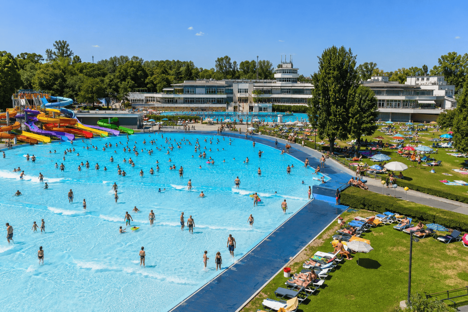 Sunlit outdoor pool at a Budapest summer bath
