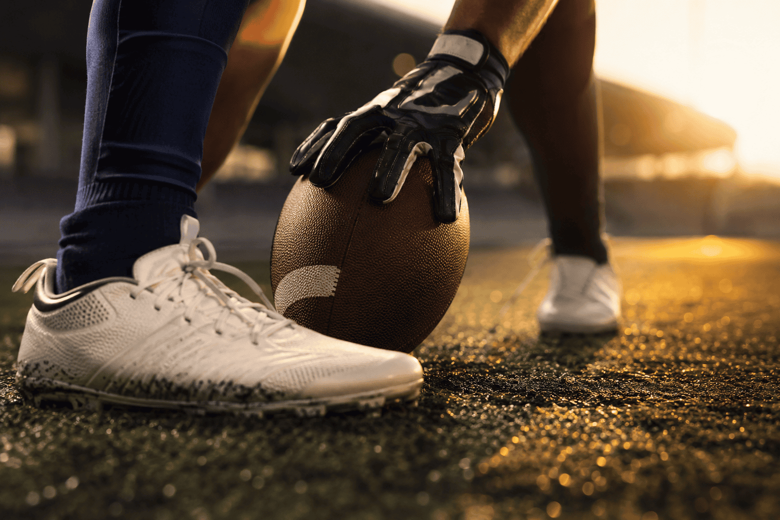 Close-up of a gloved hand holding the ball for a placekick