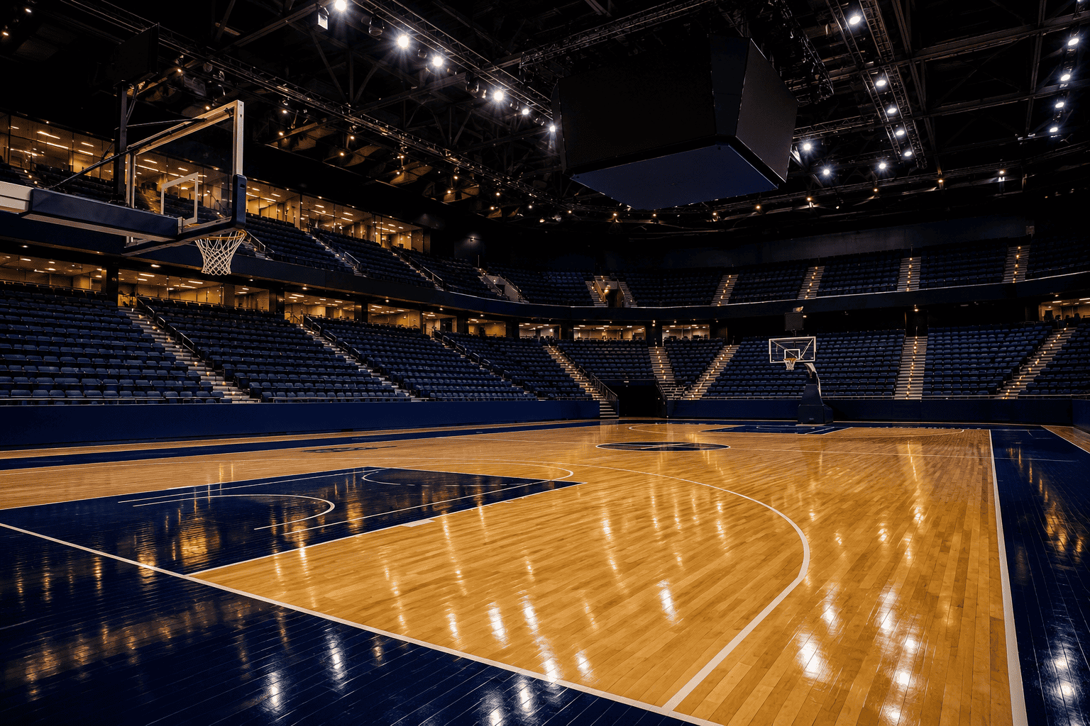 Empty basketball arena with the court lit before a game