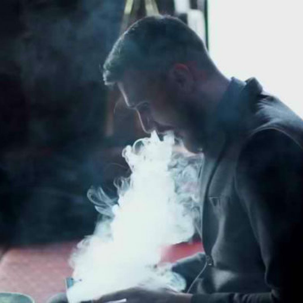 man smoking grenco elite