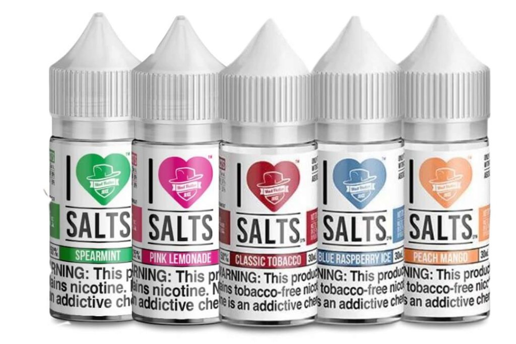 Assorted vape salt bottles featuring flavors like spearmint, pink lemonade, classic tobacco, blue raspberry, and peach mango for e-cigarette users.