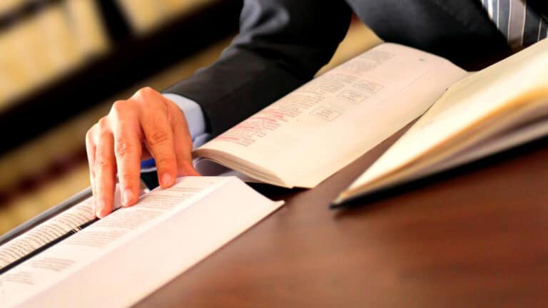 Legal professional reviewing financial documents in a law office.