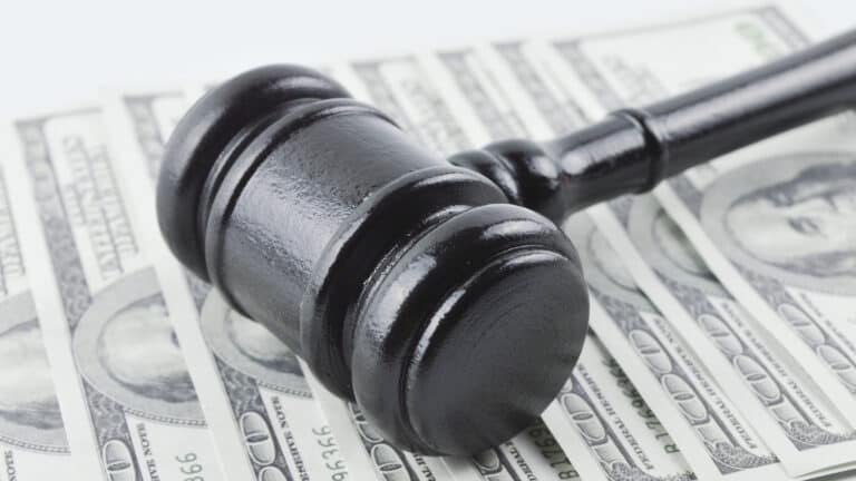 Black gavel on US dollar bills, symbolizing securities law and investment disputes in California.