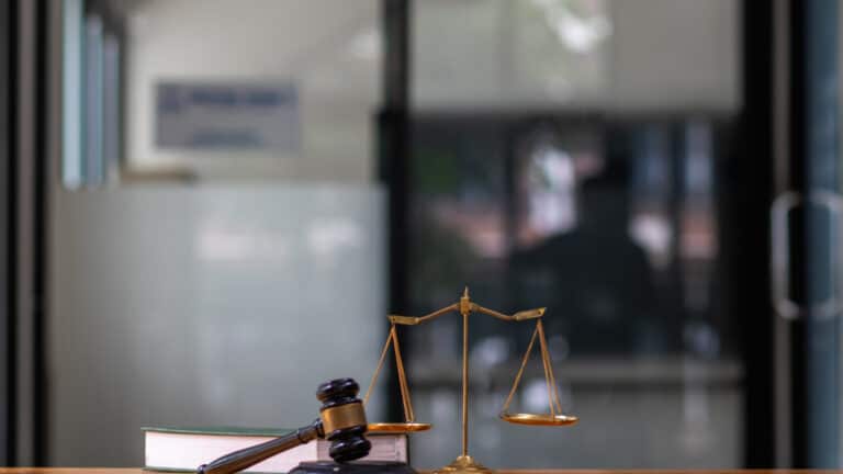 Scales of justice and gavel in a law office setting.