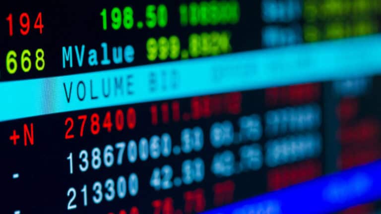 Stock market data display with numbers and graphs in blue, red, and green.