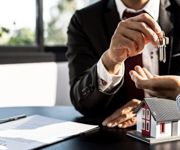 Key handover for a new home showing real estate transaction in St. Lucia, VFM Real Estate.