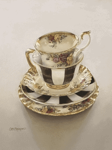 Beautiful floral teacup and saucer with gold accents, showcasing award-winning craftsmanship from th.
