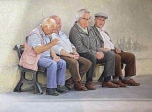 Senior men sitting on a bench at the exhibition, showcasing award-winning pastel artworks.