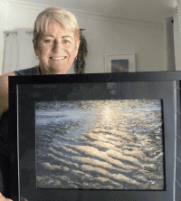 Woman holding framed pastel artwork at the Pastel Society of Victoria awards.