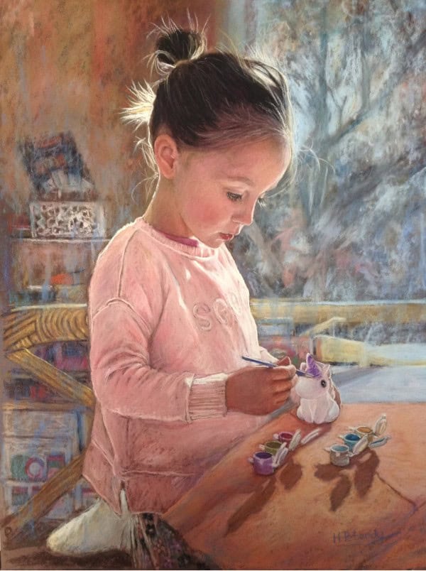 Child Painting Unicorn with Pastels.