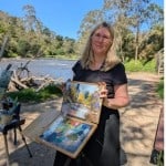 Kayleen West painting outdoors at a pastel Paint Out by the river.