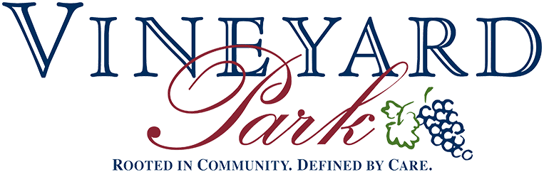 Vineyard Park Senior Living entrance with lush landscaping and welcoming atmosphere.