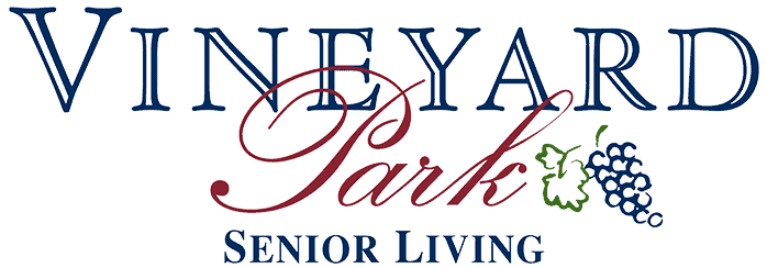 Beautiful view of Vineyard Park Senior Living entrance with lush landscaping and welcoming atmospher.