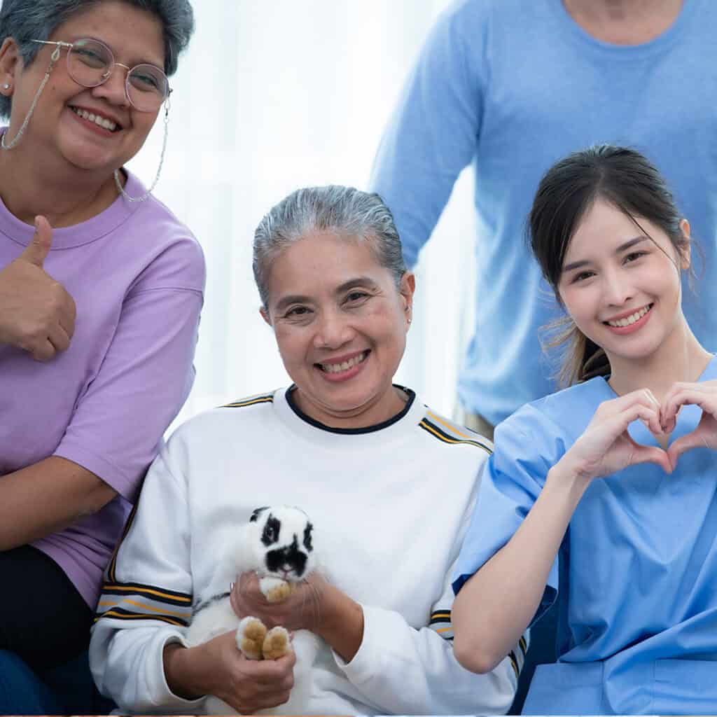 Senior woman with puppy, smiling, at Vineyard Park Senior Living community.