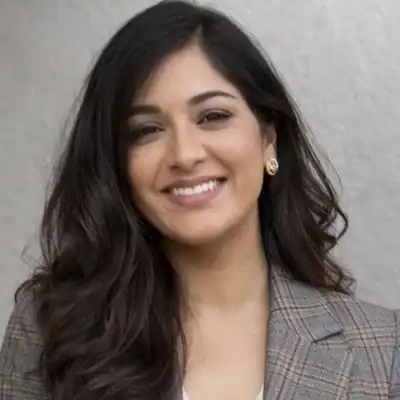 Elegant young woman smiling in a stylish apartment, showcasing Vineyard Park Living community.