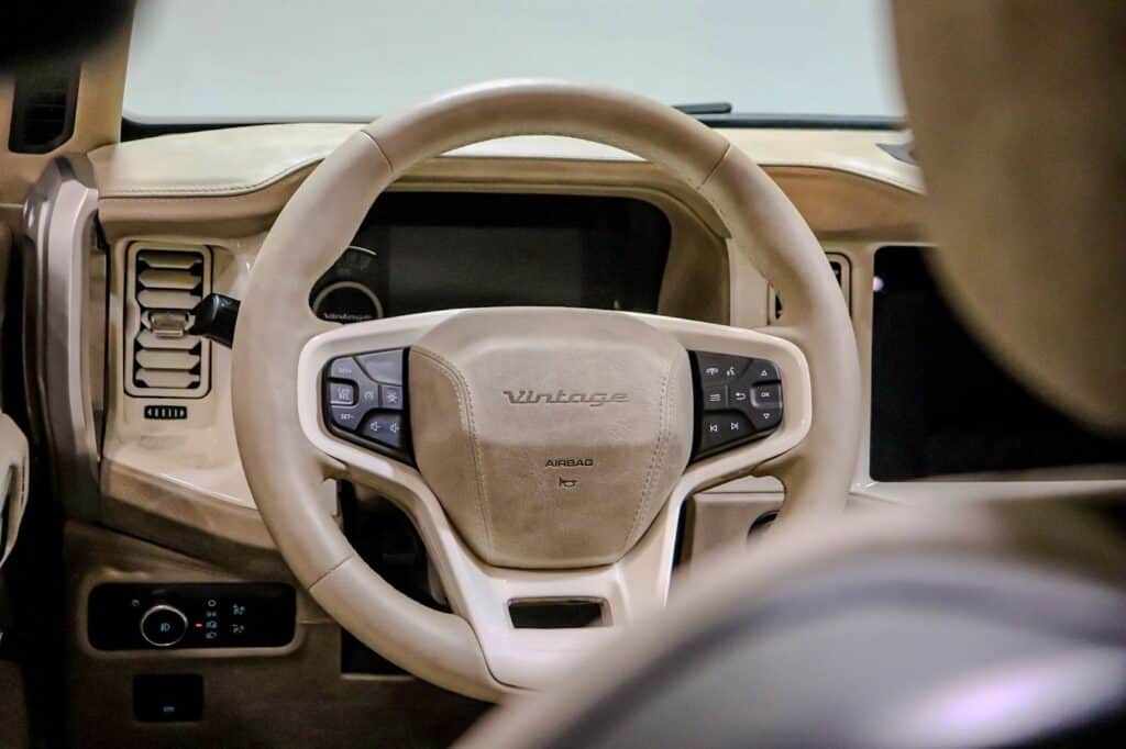 Vintage camper van interior steering wheel with beige retro design, showcasing modern amenities and classic style for a vintage modern look.