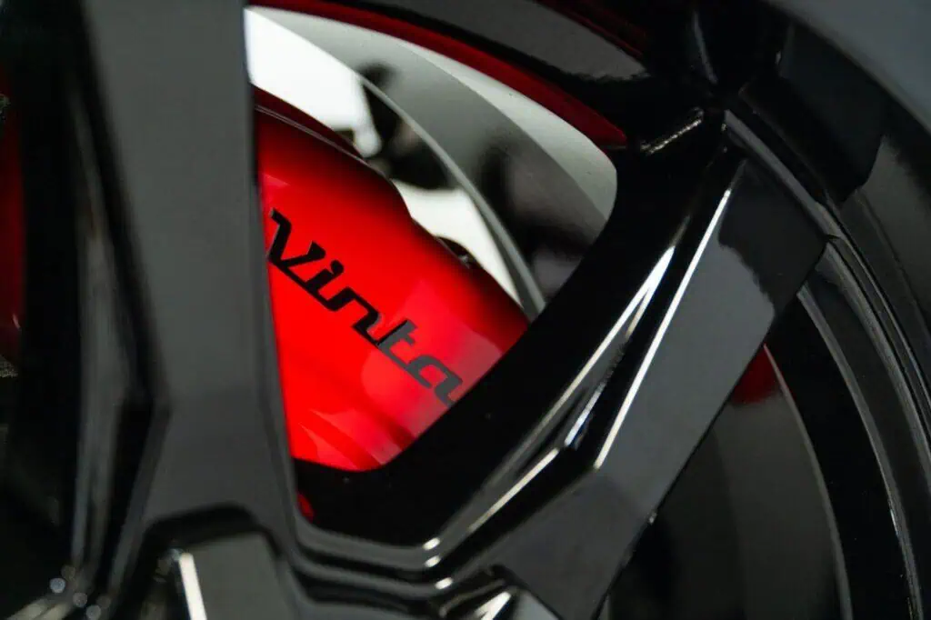 Vintagestyle motorcycle fuel tank with sleek black and red finish, showcasing modern vintage design elements for a stylish ride.