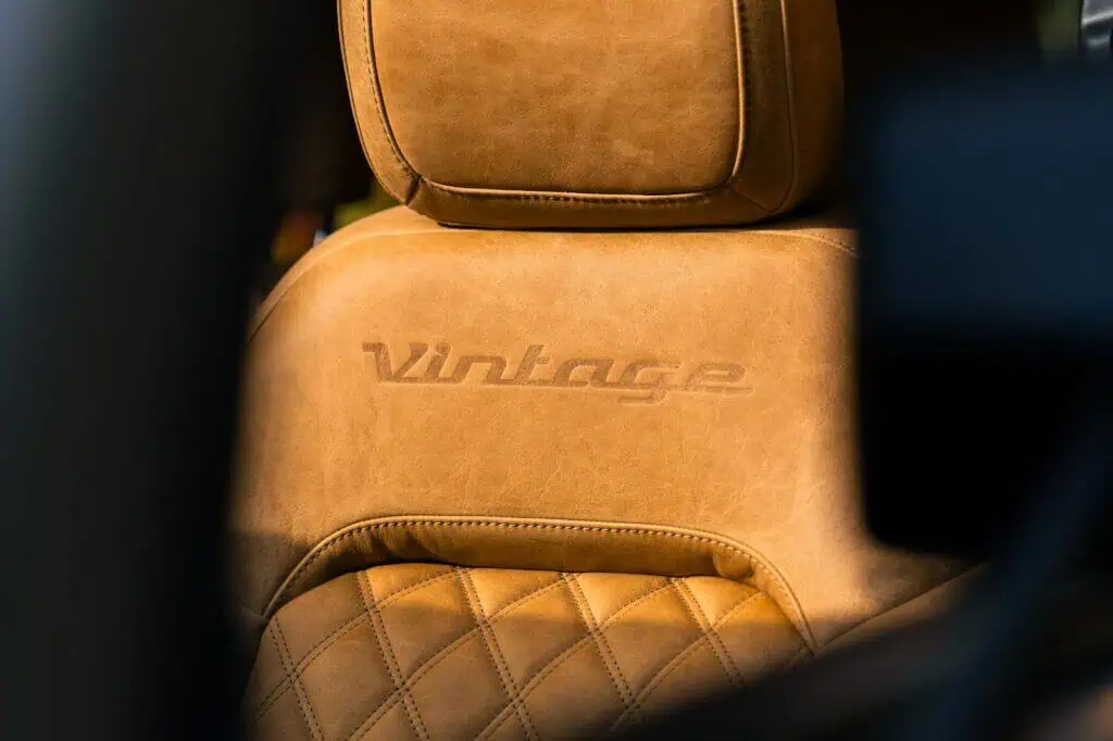 Vintage leather car seat with embossed "Vintage" logo, showcasing retro automotive design and craftsmanship. Perfect for vintage car enthusiasts and collectors.