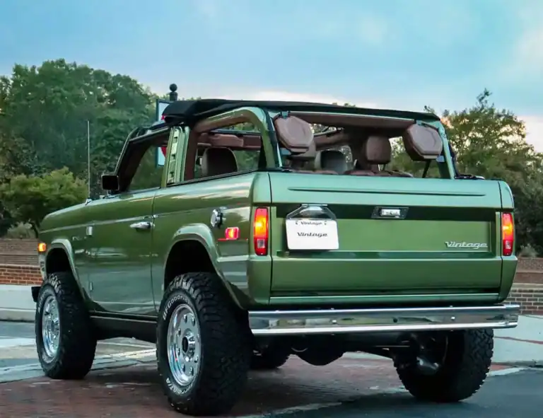 Retro vintage green off-road SUV with open roof, classic design, and rugged tires at Vintage Modern.