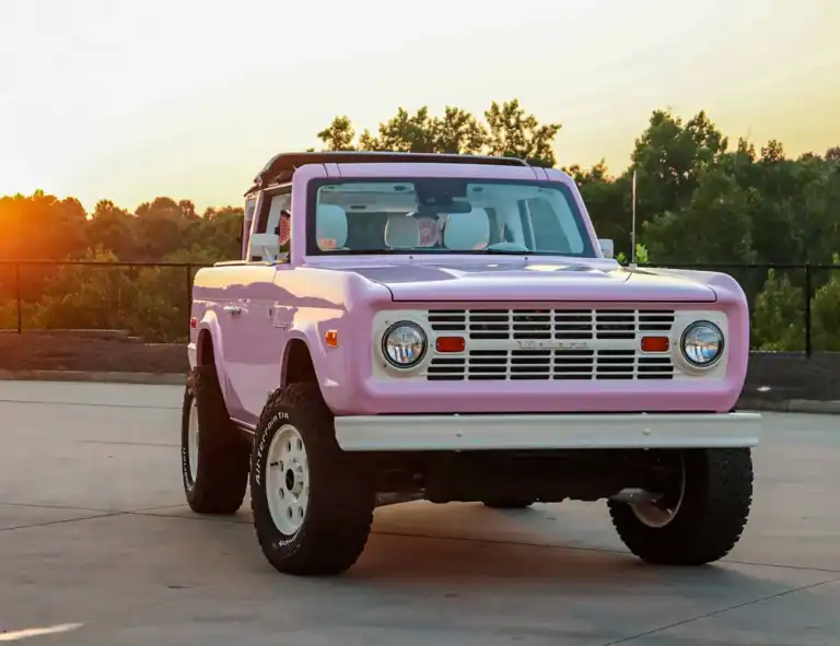 Pink vintage off-road vehicle with retro design and modern modifications, ideal for classic car enthusiasts and outdoor adventures.