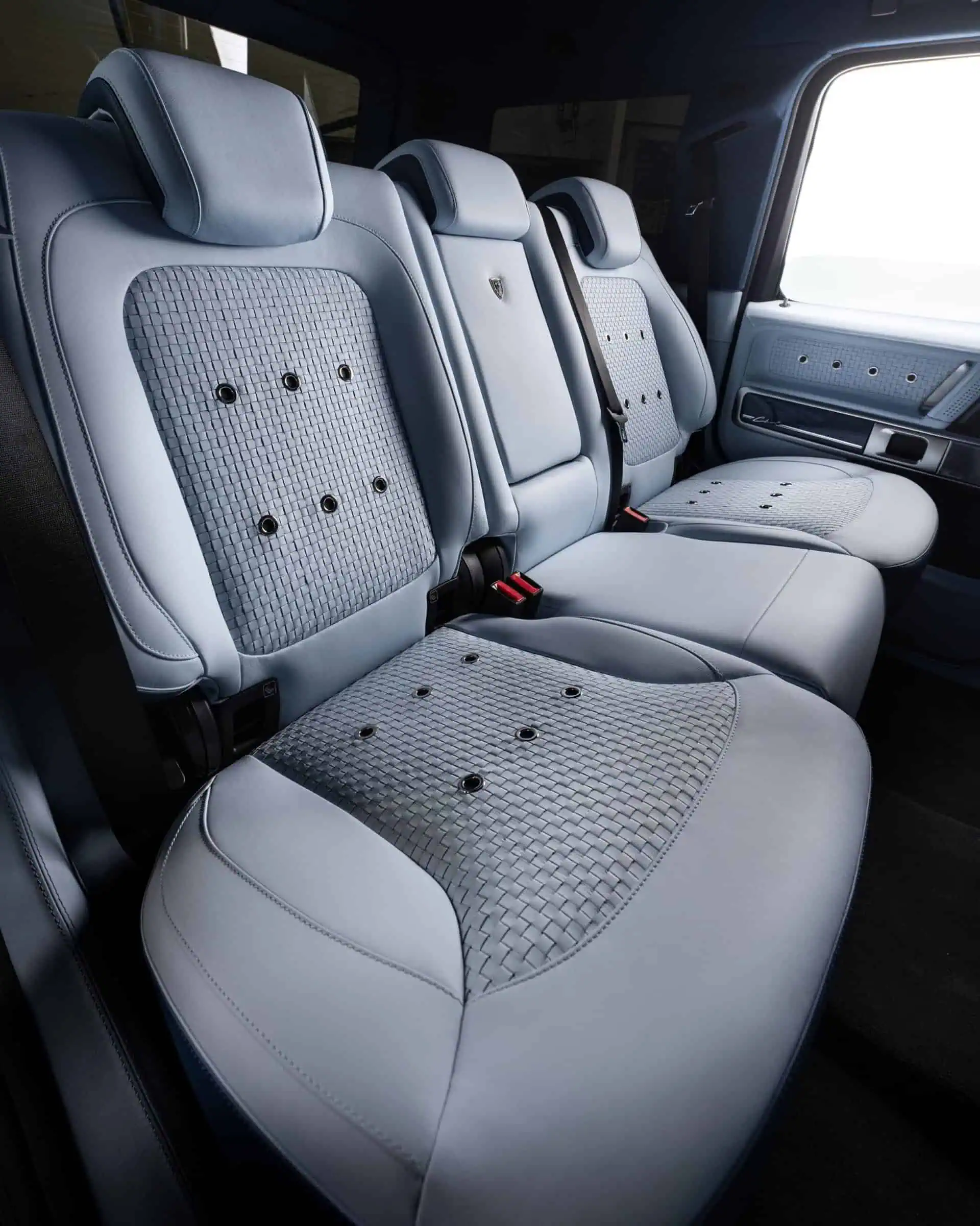 Luxury leather car seats with quilted fabric accents and adjustable headrests, showcasing premium automotive design and comfort. Perfect for luxury vehicle customization and stylish interiors.
