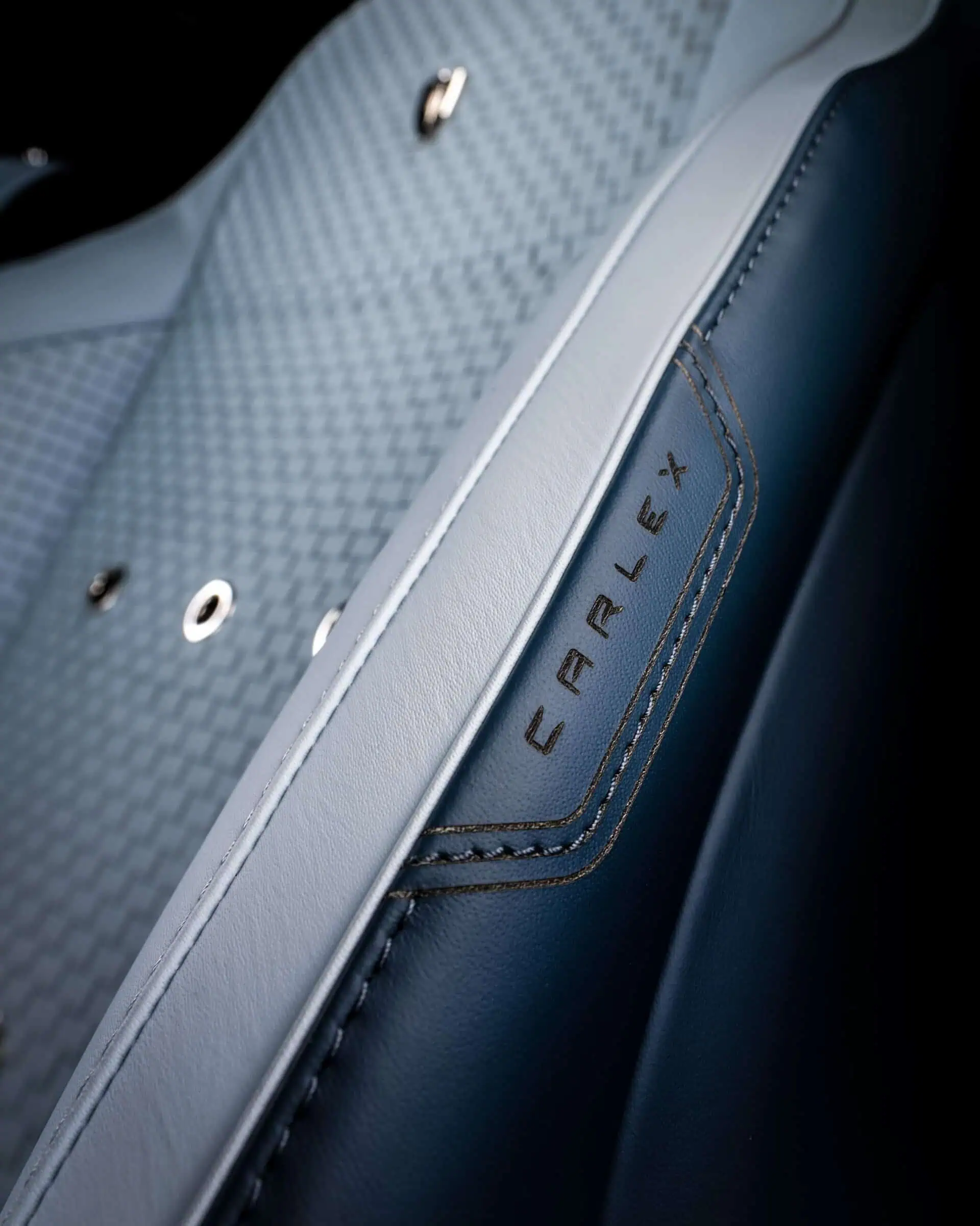 Close-up of luxury car seat with "FURREX" branding featuring high-quality leather, stitching, and modern design elements for a sleek, sophisticated look.