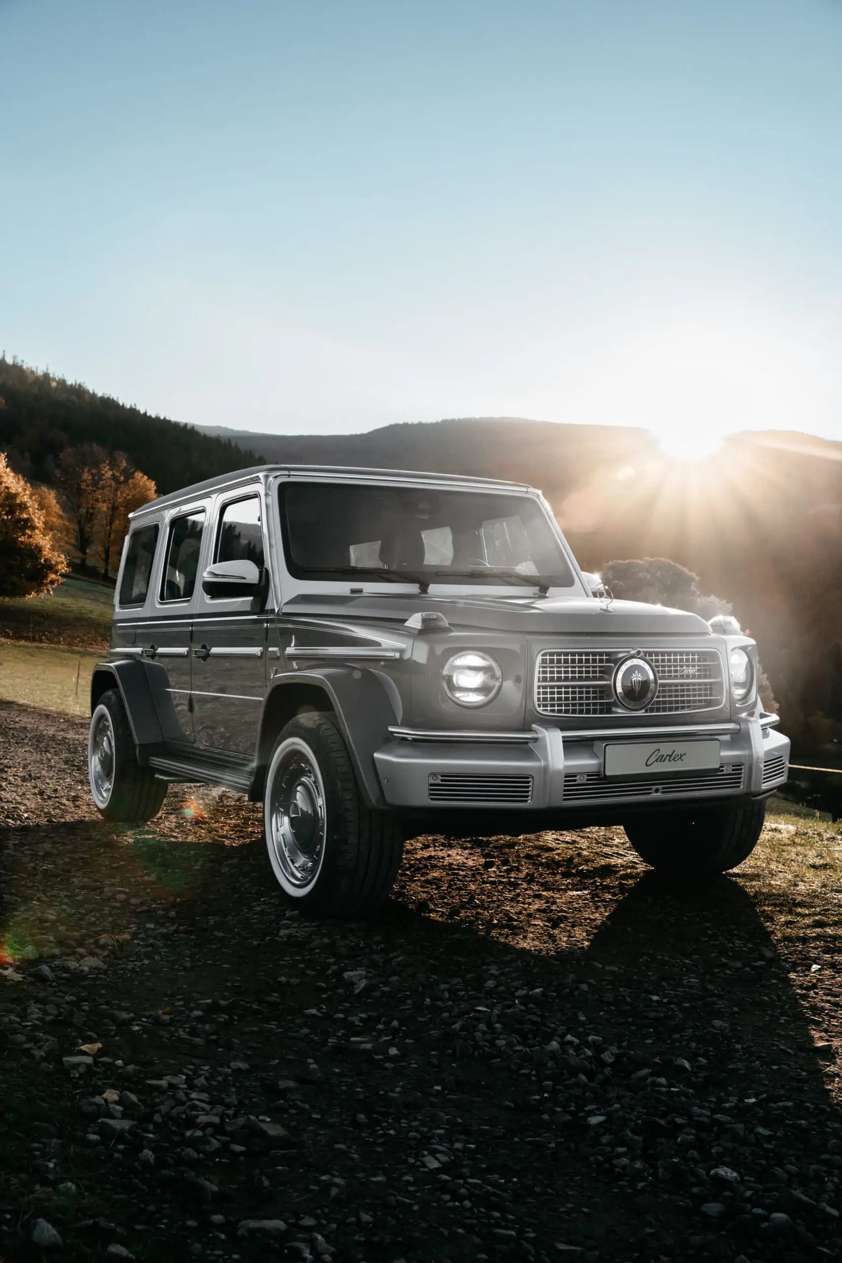 Classic vintage modern off-road SUV in scenic outdoor landscape during sunset, emphasizing retro-inspired design and timeless style for automotive enthusiasts.