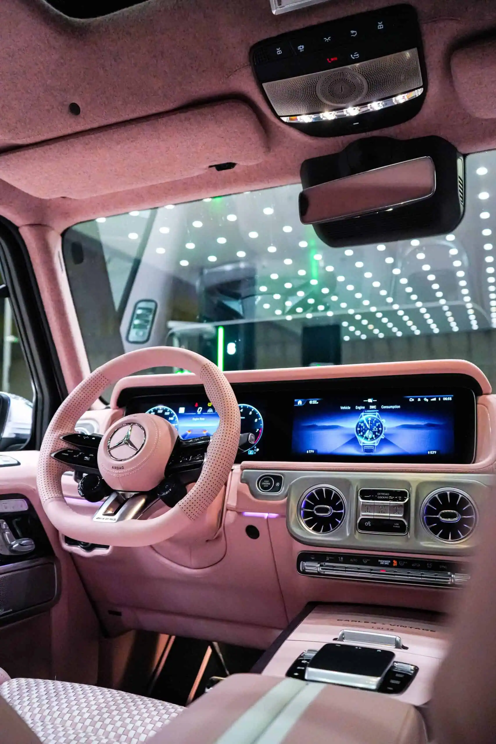 Stunning vintage Mercedes-Benz interior featuring a luxurious pink theme and advanced digital controls, blending classic and modern design.