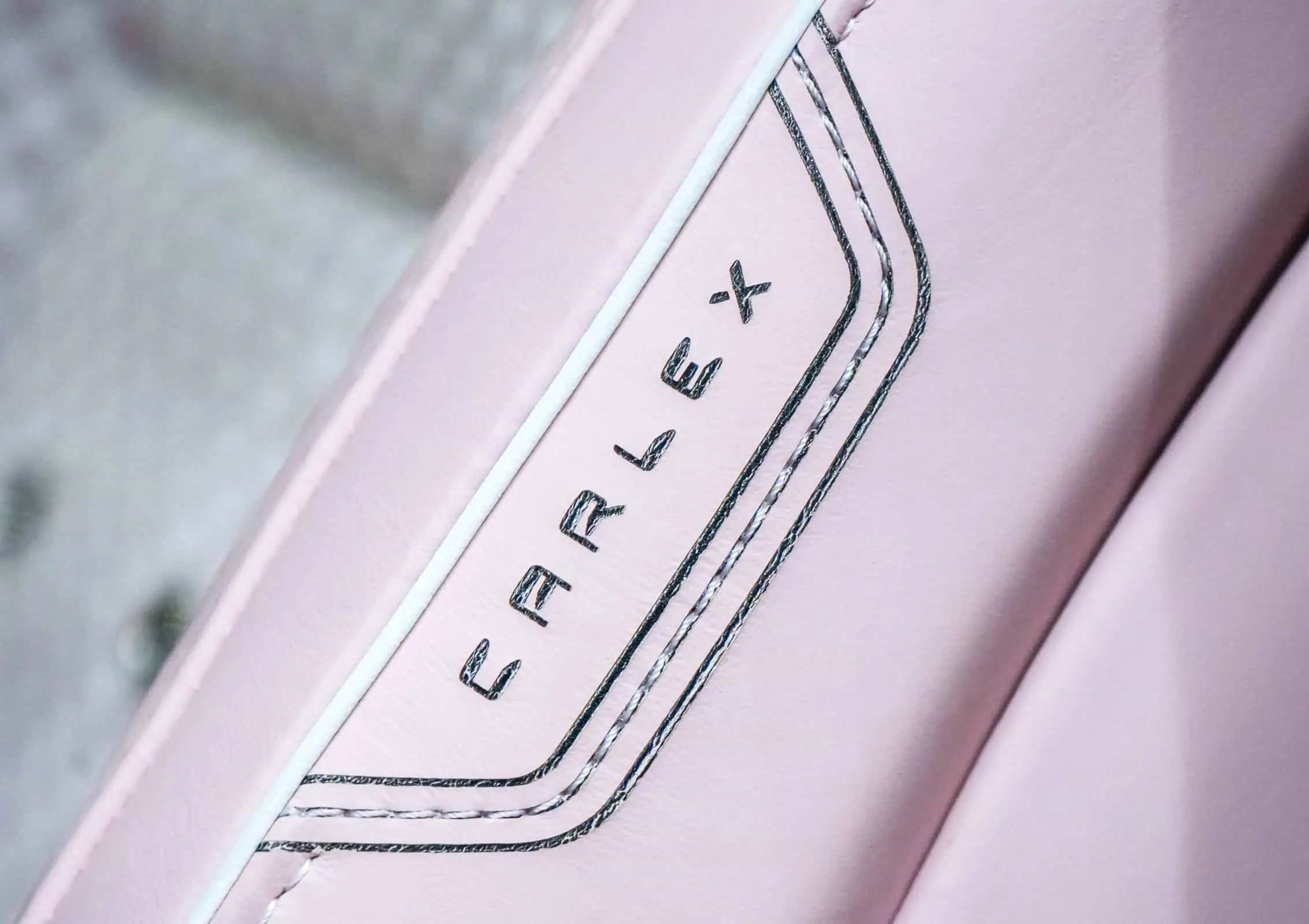 Close-up of a pink vintage modern appliance with sleek black lettering. Perfect for home decor, blending retro and contemporary styles.