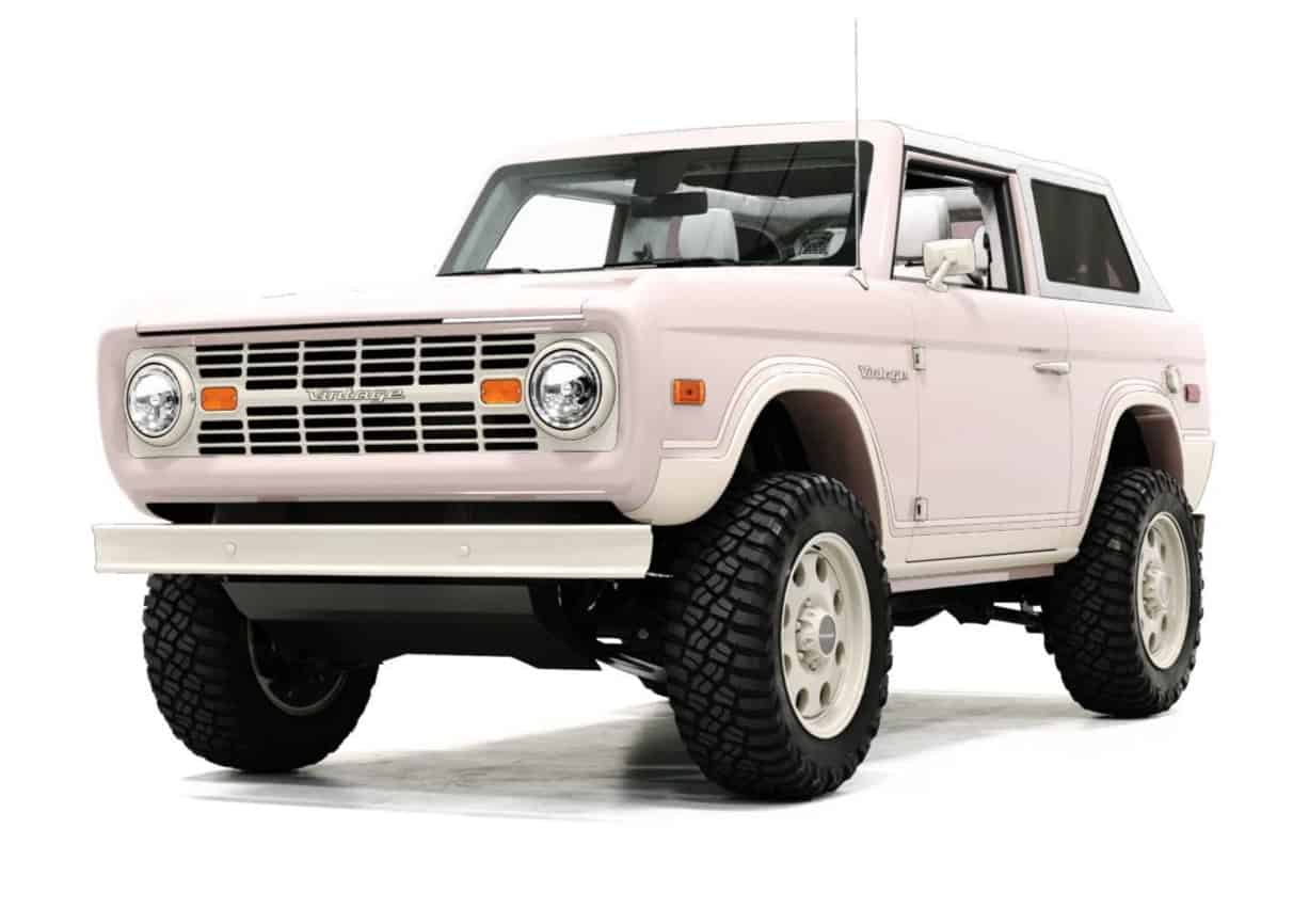 Pink vintage off-road vehicle with rugged tires, classic design, and modern retro style, perfect for stylish outdoor adventures and showcasing timeless automotive elegance.