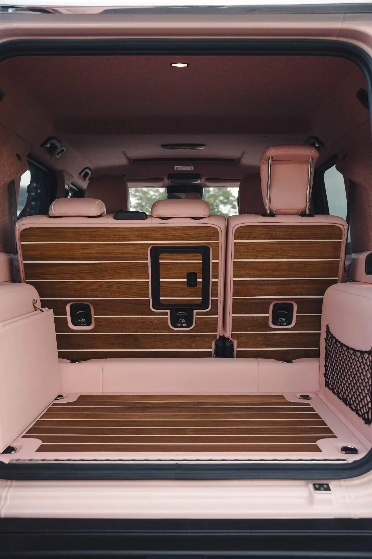 Car interior, vintage modern style, pink leather seats, wooden trim, luxury vehicle, stylish car design, premium automotive interior.