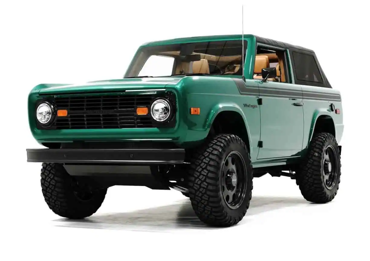 Classic British Racing Green vintage SUV with rugged off-road tires and retro design, perfect for outdoor adventures and stylish urban driving.