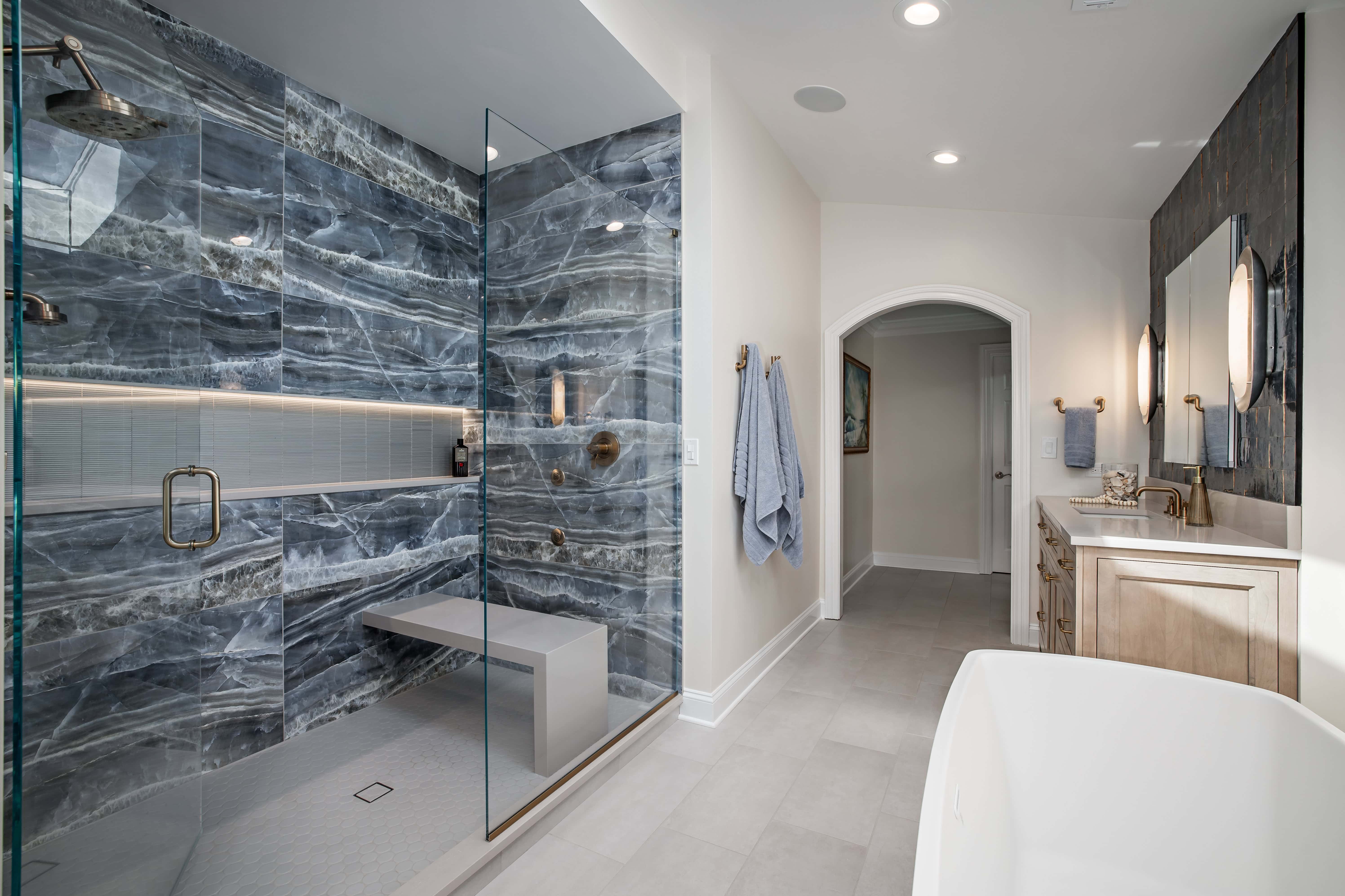 Custom shower with tiled floor and bench.