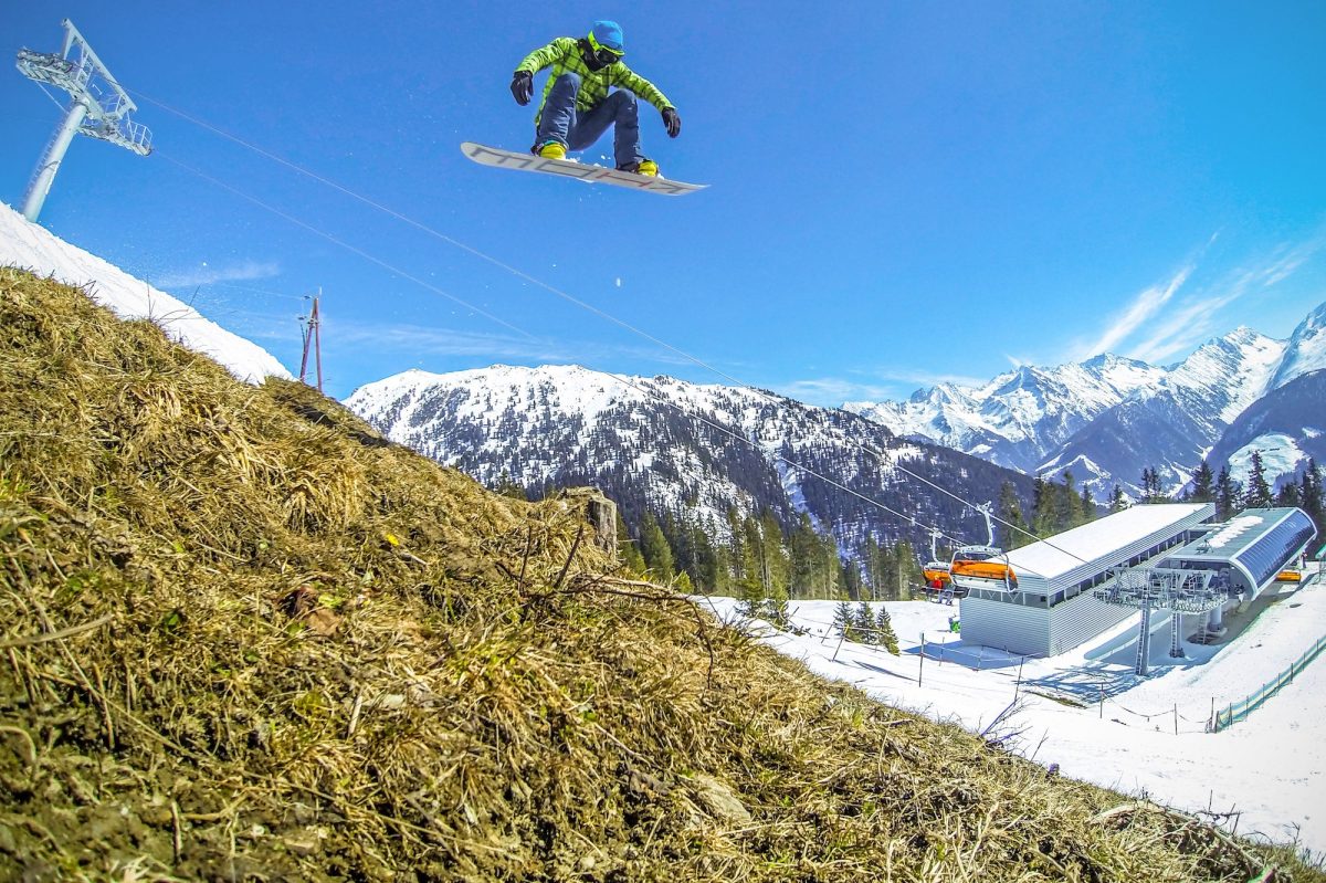 Snowboarder jumping over snowy landscape