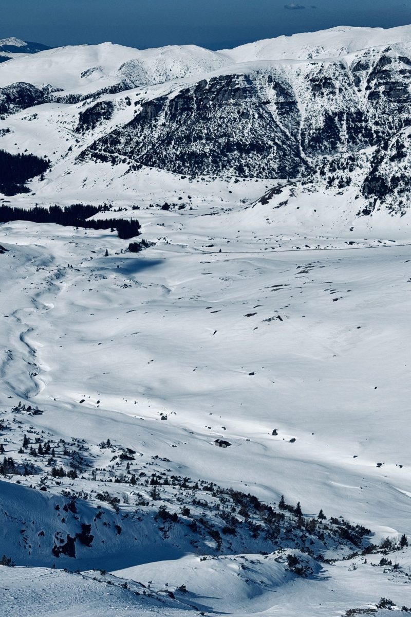 Snow-covered mountain landscape with expansive winter scenery and snow-covered slopes.