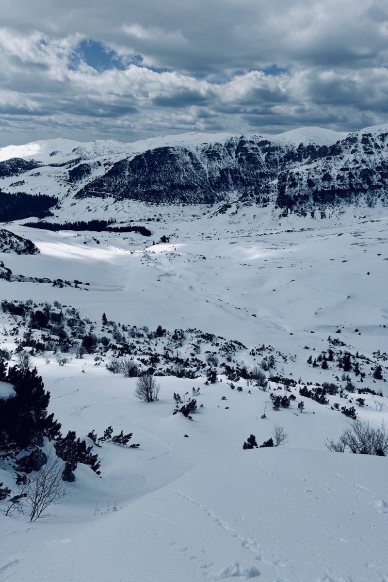 Snowy mountains under cloudy sky