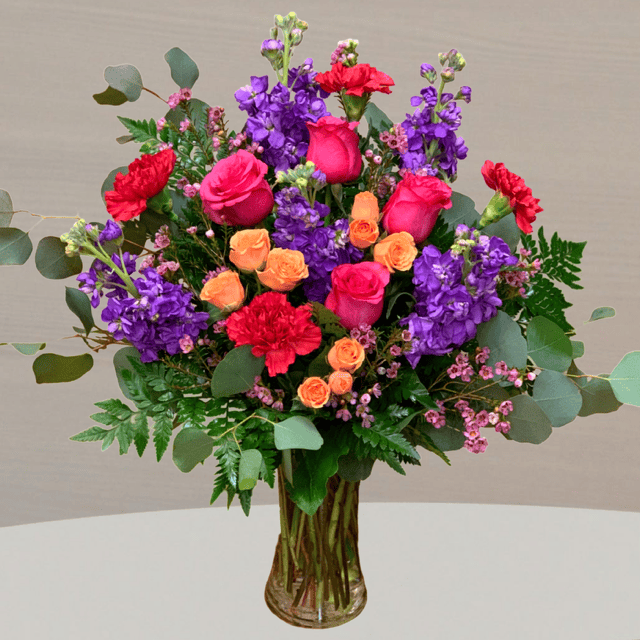 Beautiful floral arrangement featuring vibrant pink, purple, and orange flowers, perfect for celebrating Mother's Day and expressing love.
