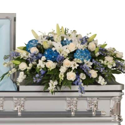 Blue and White Casket Spray made with blue flowers, white roses for delivery in Las Vegas, NEVADA