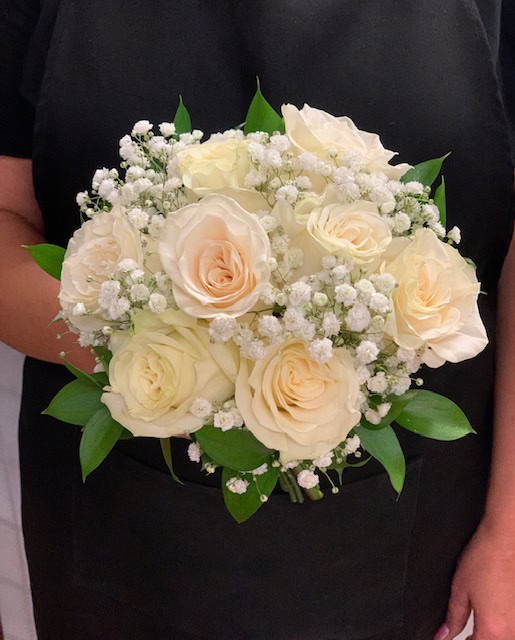 Elegant white rose bouquet with baby's breath and green foliage, perfect for special occasions or gifts in Las Vegas.