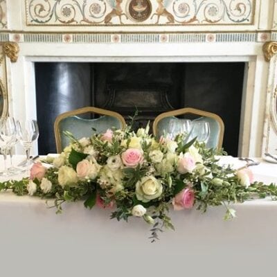 blush roses and white roses sweetheart table flower centerpiece