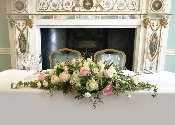 blush roses and white roses sweetheart table flower centerpiece