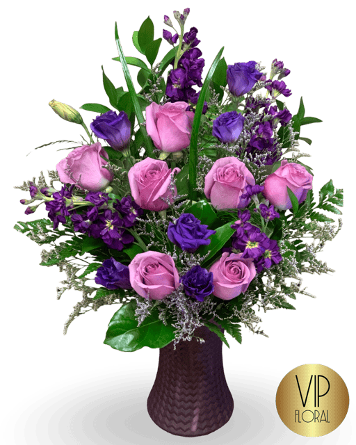 Elegant lavender and pink floral arrangement with roses and lisianthus.