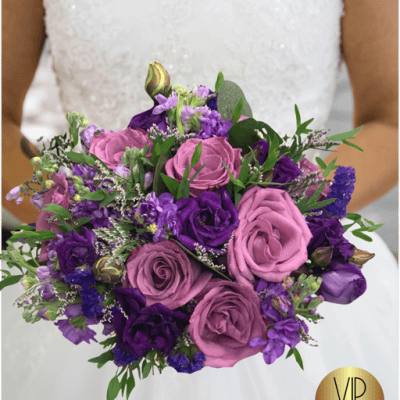 Adore bridal bouquet is made with purple and lavender shade fresh flower colors.