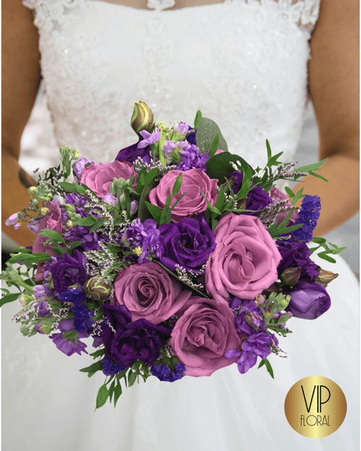 Adore bridal bouquet is made with purple and lavender shade fresh flower colors.