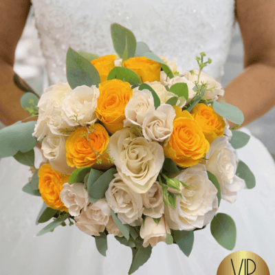 Sin City Splendor Ensemble is a bridal bouquet with white and yellow roses, and silver dollar eucalyptus