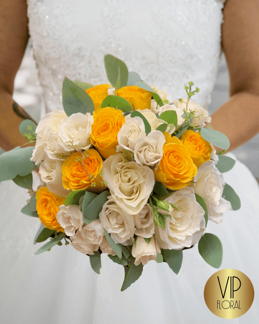Sin City Splendor Ensemble is a bridal bouquet with white and yellow roses, and silver dollar eucalyptus