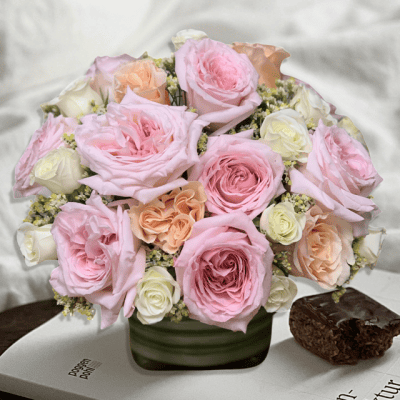 Pastel Petals Cube with garden roses very fragrant, peach roses and white spray roses.