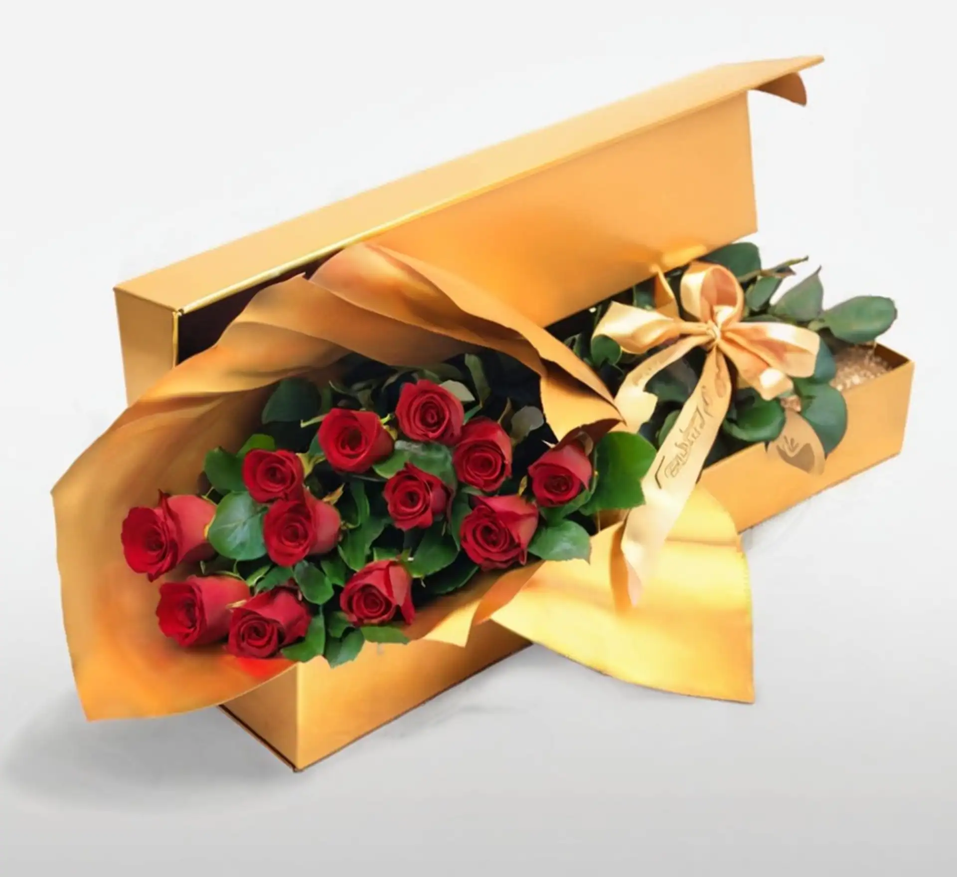 Lush red roses in a luxurious gold gift box with elegant wrapping, perfect for special occasions or romantic gestures.